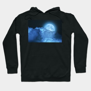 Blue super moon glowing against starry cloudy sky Hoodie